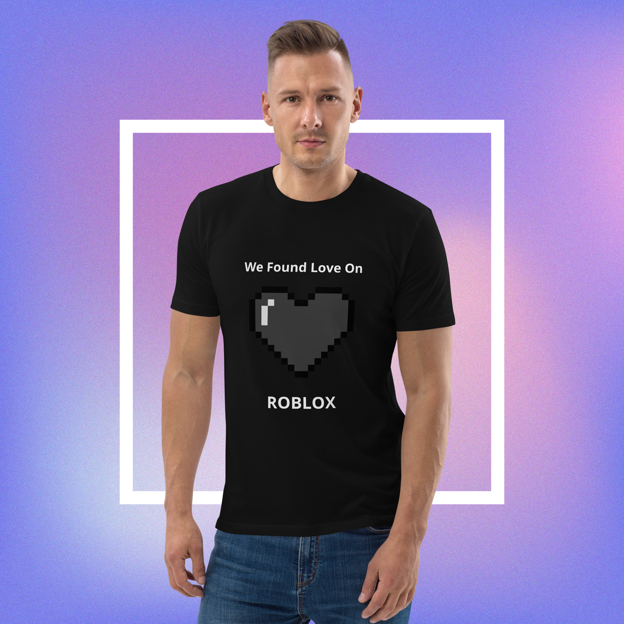 A man wearing a black t-shirt with a pixelated heart graphic and the text 'We Found Love On ROBLOX' printed on the front, set against a purple and blue gradient background with a white square frame.